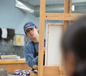 student painting a portrait