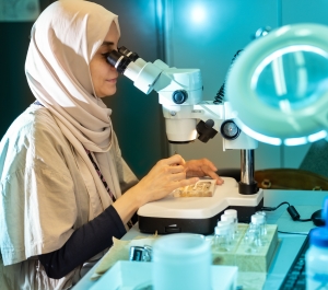 Student looking through microscope