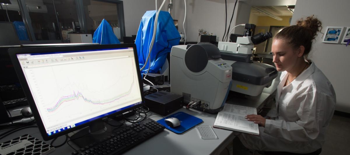 Student Researcher using Raman spectrophotometer