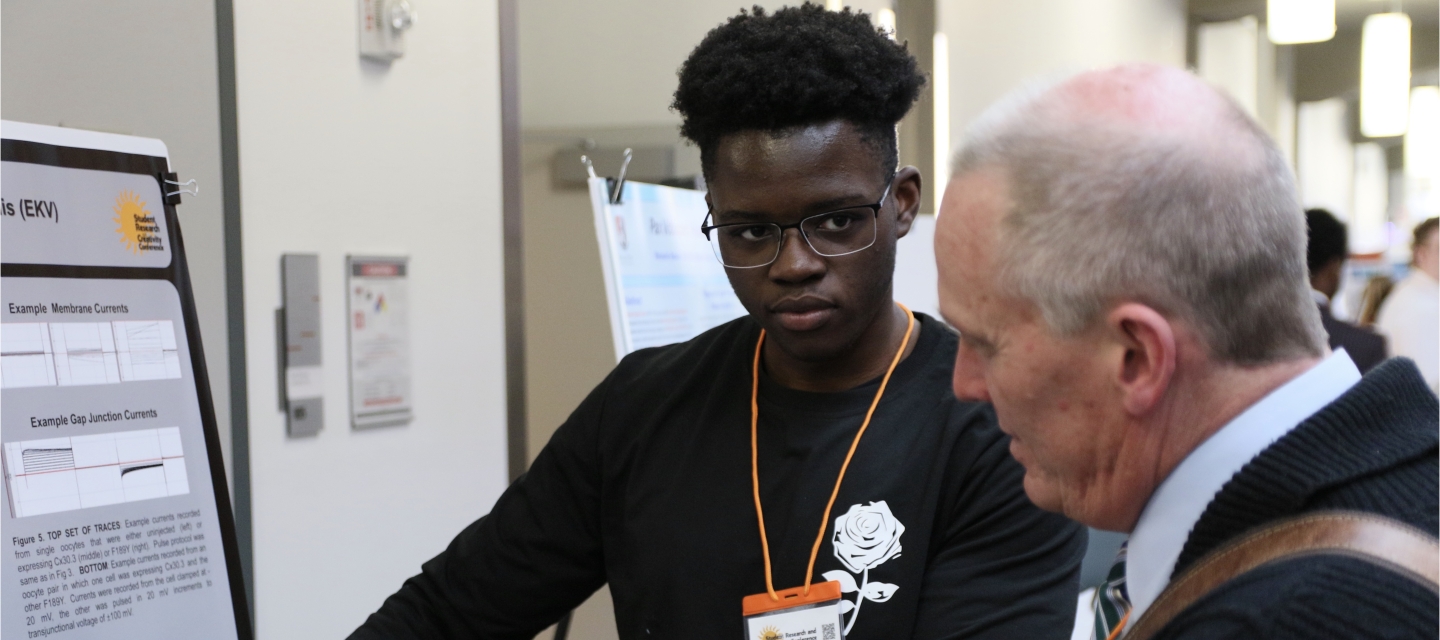 Research student explaining poster